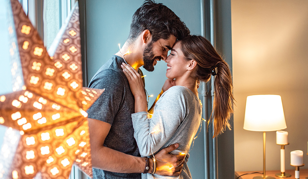 happy couple and holiday lights